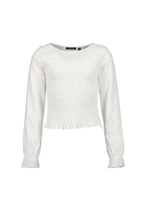 Blusa blanca de manga larga con fruncido en el frente y la espalda, escote redondo y puños y dobladillo con volantes.