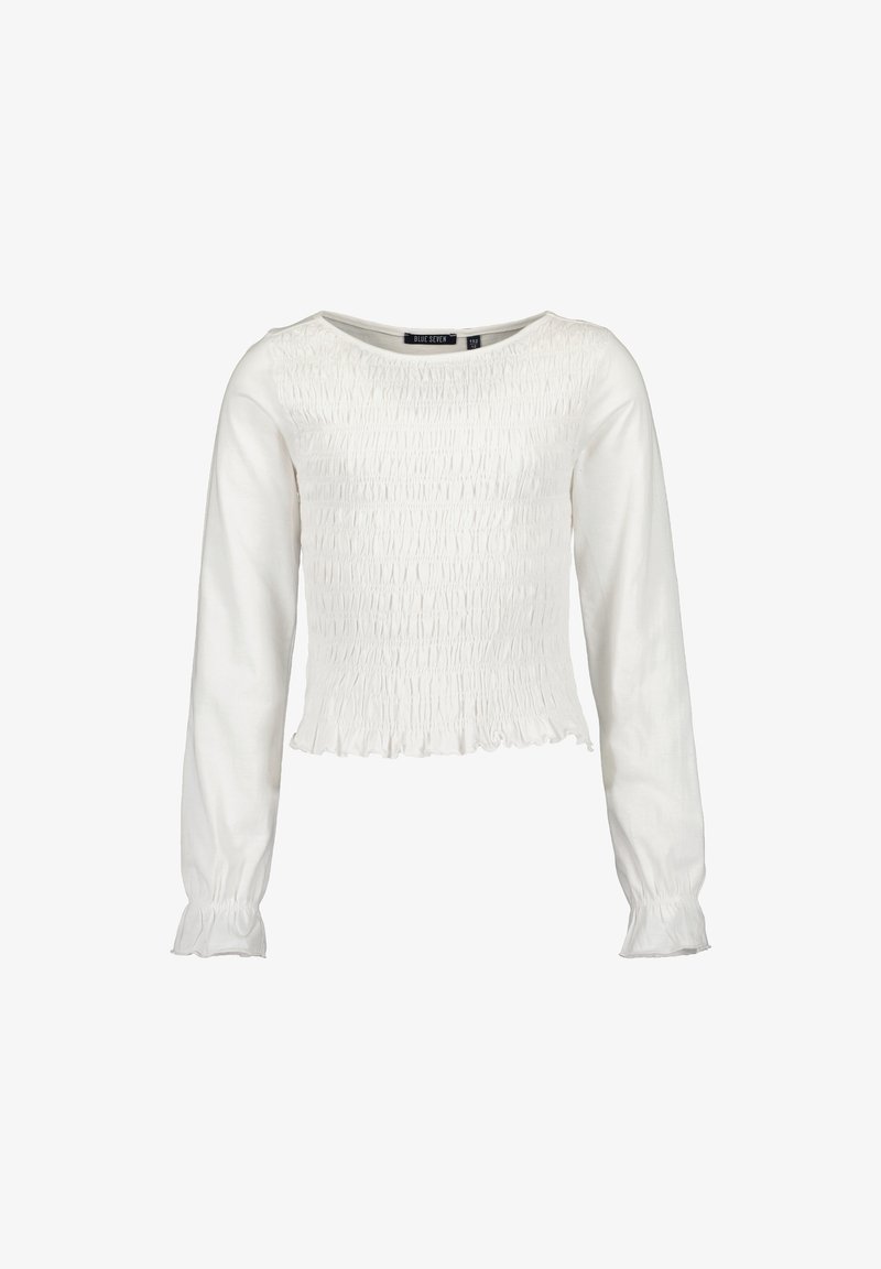 Blouse blanche à manches longues avec devant et dos froncés, encolure ronde et poignets et ourlet à volants.