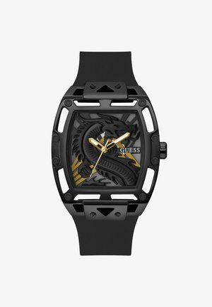 Hodinky s černým gumovým páskem a čtvercovým pouzdrem, se strukturálním designem draka, zlatými akcenty a černým ciferníkem se stříbrnými ručičkami.