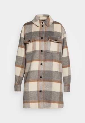 Veste-chemise en laine à carreaux beige, gris et marron. Comprend deux poches poitrine, une fermeture à boutons et un col classique. Texture douce.