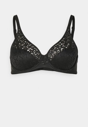 Black bra featuring a lace overlay on the cups, smooth fabric underband, adjustable straps, and classic underwire design.