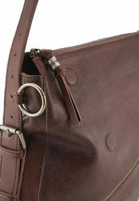 Borsa a mano in pelle marrone con finitura texture, chiusura a zip, hardware metallico e un pon-pon decorativo in pelle. Presenta una tracolla regolabile e resistente.