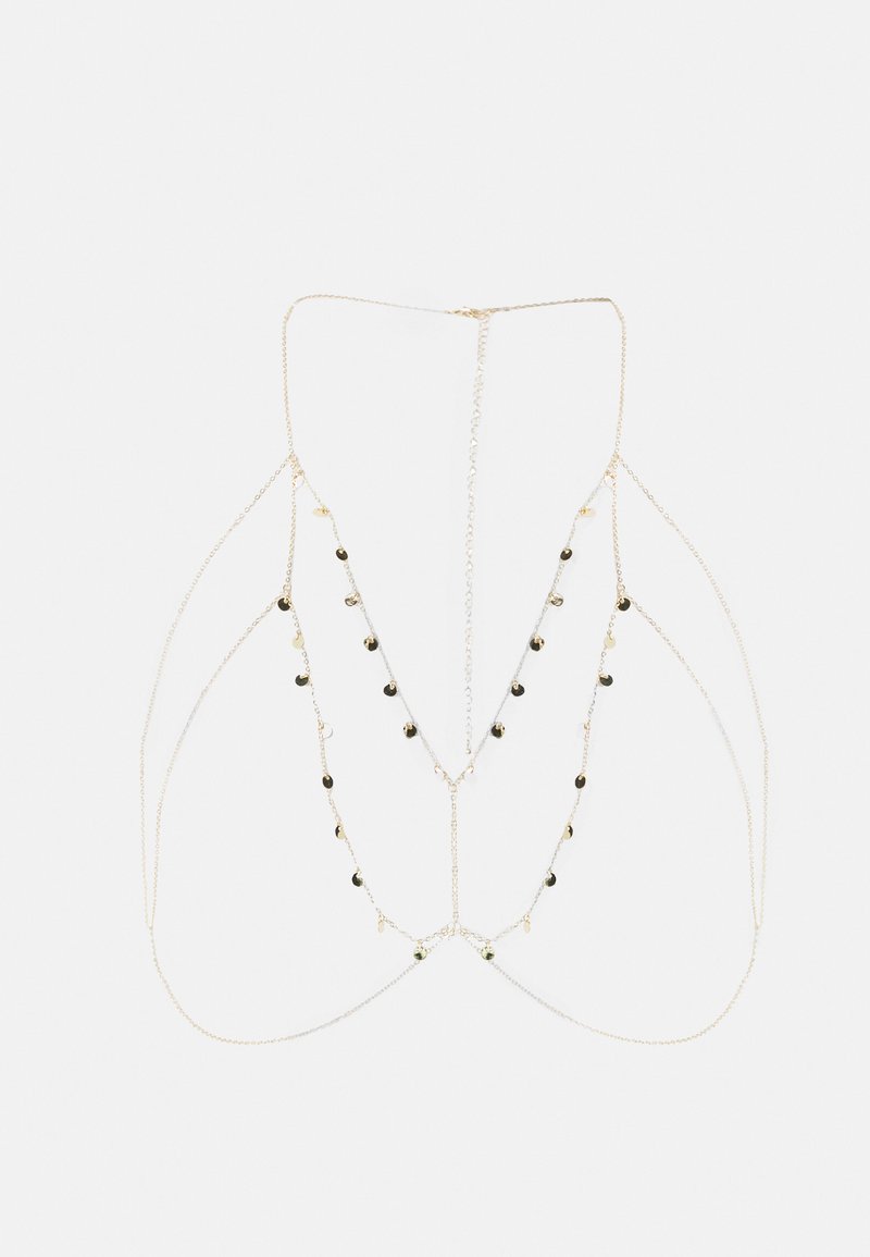 Goudkleurige gelaagde bodychain met meerdere dunne kettingen, voorzien van metalen kralen en een delicaat ontwerp, gerangschikt in een geometrisch patroon.