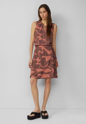 Sleeveless dress in earthy tones, featuring a ruffled neckline and abstract pattern. A wrap style with a tied waist and flowy skirt.