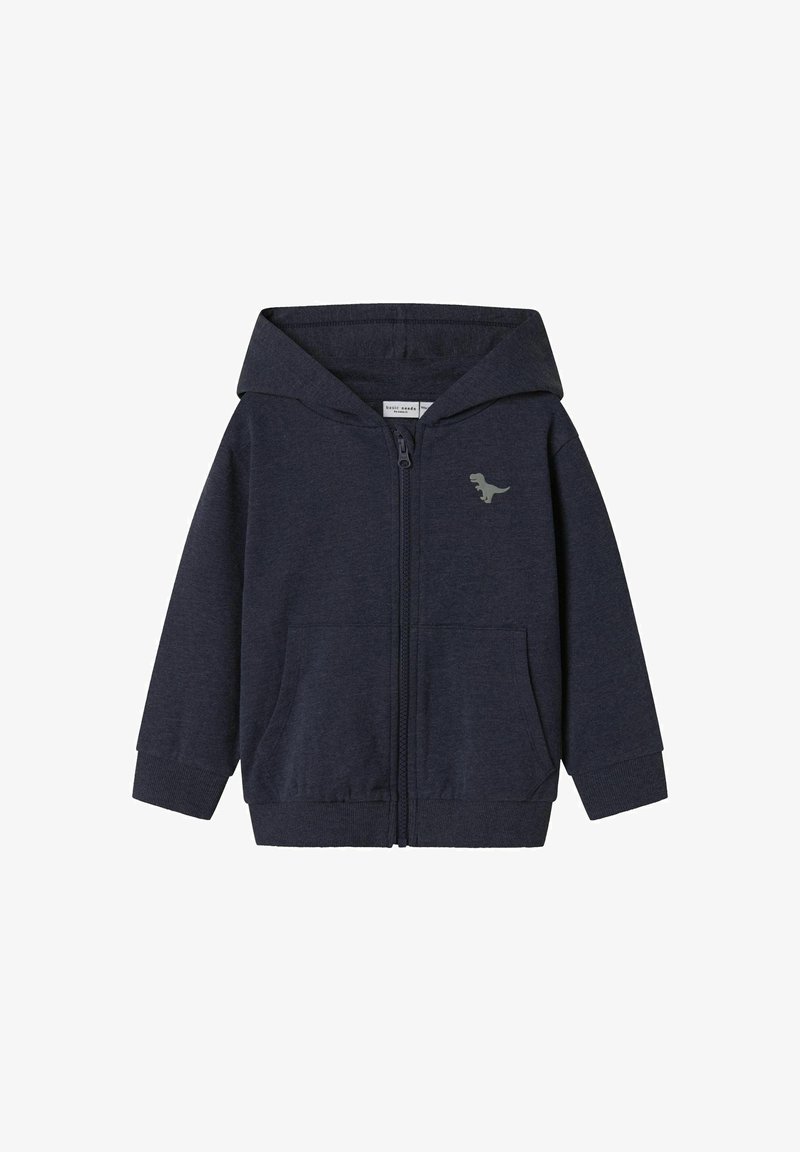 Sweat à zip en navy en coton doux, avec une poche avant et un graphique de dinosaure sur la poitrine gauche. Comprend une capuche spacieuse.