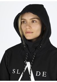 Black pullover hoodie with a front logo, drawstring hood, smooth texture, and a relaxed fit. Features a high collar and minimal design details.