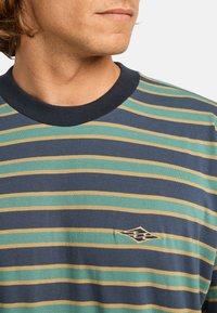 Navy blue short-sleeve shirt with horizontal stripes in green and yellow, featuring a small embroidered diamond logo on the chest.