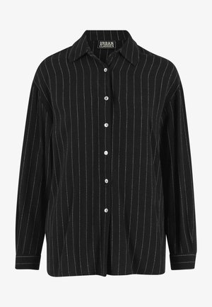 Zwart shirt met lange mouwen en witte verticale strepen, ontwerp met knopen en een klassieke kraag. De stoftextuur lijkt zacht en glad.