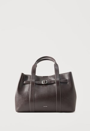 Dark brown leather handbag with dual handles, a front buckle strap, and Calvin Klein logo on smooth surface.