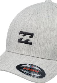 Gray fabric cap featuring a black wave logo on the front. The design includes a textured finish and a curved brim. Flexfit brand sticker attached.
