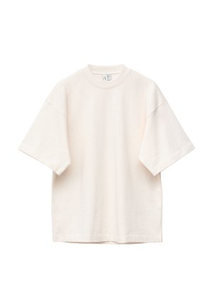 Übergroßes, kurzärmeliges T-Shirt in Cremefarbe mit Rundhalsausschnitt, lockerem Sitz und sichtbaren Nähten an Ärmeln und Schultern.