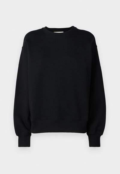 Sweatshirt preto com gola redonda, mangas compridas e punhos canelados. Feito de um tecido macio com uma textura suave. Design simples.
