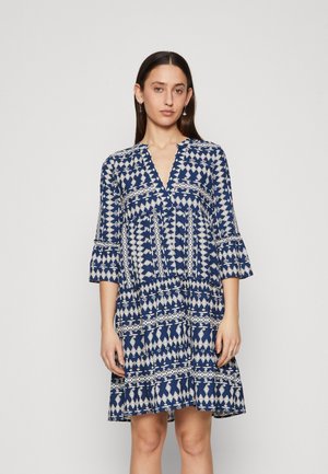 Navy blue dress with white geometric patterns, V-neckline, three-quarter sleeves, and a flared hem. Made of lightweight fabric.