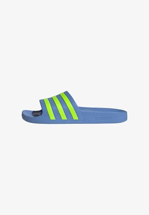 Blue slide sandal with three bright green stripes. Made of rubber, featuring a textured footbed and the embossed logo on the side.