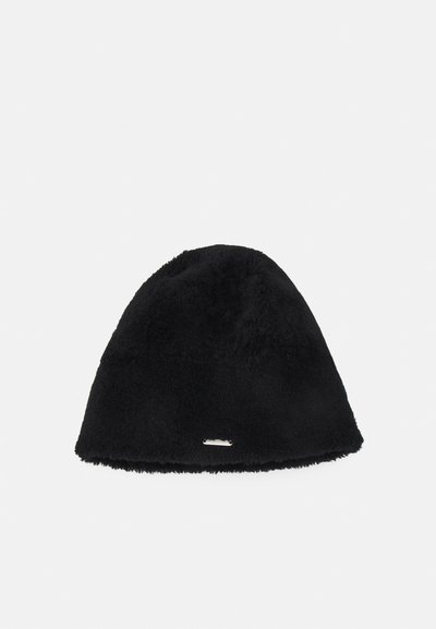 Bonnet en polaire noire au toucher doux, avec une forme arrondie et un petit accent métallique sur le bord avant. Design compact et chaud.
