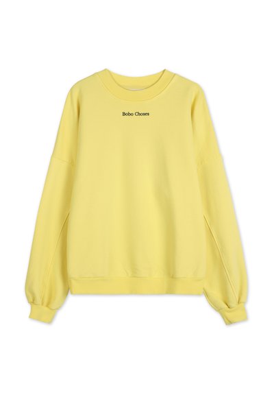 Gul bomullströja med långa ärmar, rundad halsringning och volangärmar. Funktioner "Bobo Choses" broderat i svart framtill.
