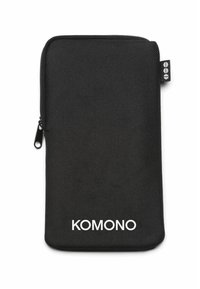 Pochette zippée en tissu noir avec surface texturée, arborant le logo blanc "KOMONO" sur l'avant et une petite étiquette de marque sur le côté.