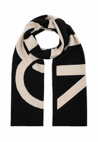 Czarny i kremowy szalik w kształcie prostokąta, z wyrazistymi geometrycznymi wzorami. Wykonany z miękkiego materiału, o gładkiej fakturze i czystych krawędziach.