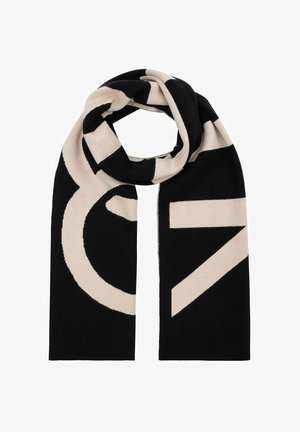 Czarny i kremowy szalik w kształcie prostokąta, z wyrazistymi geometrycznymi wzorami. Wykonany z miękkiego materiału, o gładkiej fakturze i czystych krawędziach.