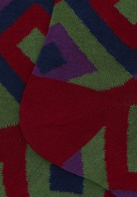 Knit socks featuring a geometric pattern in red, green, navy, and purple, with a soft texture and reinforced cuff.