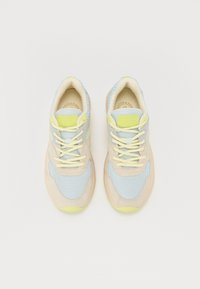 Lightweight sneakers with a mesh and suede upper in pastel blue, beige, and lime green. Features matching laces and logo. Rounded toe.