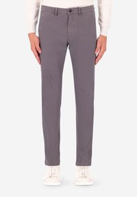 Pantaloni chino in cotone grigio con vestibilità slim, caratterizzati da una parte frontale piatta, design con cinque tasche e chiusura con bottone, abbinati a sneakers bianche.
