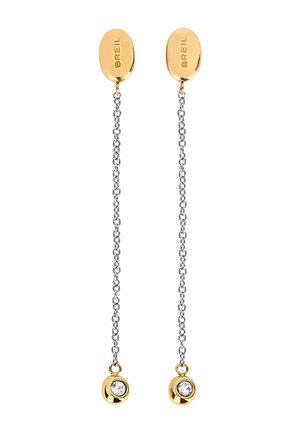 Pendientes en tono dorado con studs en forma ovalada, que presentan una cadena en tono plateado y acentos dorados, terminando en un charm redondo con una piedra preciosa transparente.