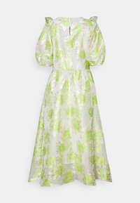 Blommig klänning i genomskinligt vitt tyg med gröna blommönster, puffärmar, nyckelhålsrygg och en flödande silhuett.