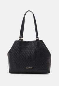 Black woven leather handbag with dual flat handles, a structured silhouette, and a gold logo accent on the front. Textured surface.