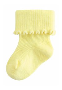 Calcetín amarillo para bebé con textura acanalada y puño con volantes, tejido de punto suave, diseñado para bebés.