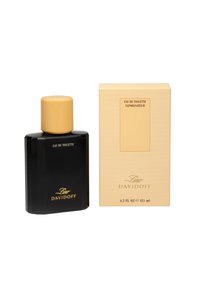 Schwarze Glasflasche mit goldenem Deckel, beschriftet mit "Eau de Toilette." Kommt mit einer hellbeigen rechteckigen Schachtel mit vertikalen Linien und goldener Schrift.
