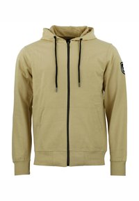 Sudadera con cremallera color beige, con capucha ajustable, cremallera negra y bolsillos laterales. Puños y dobladillo acanalados, con un parche de logo en la manga.