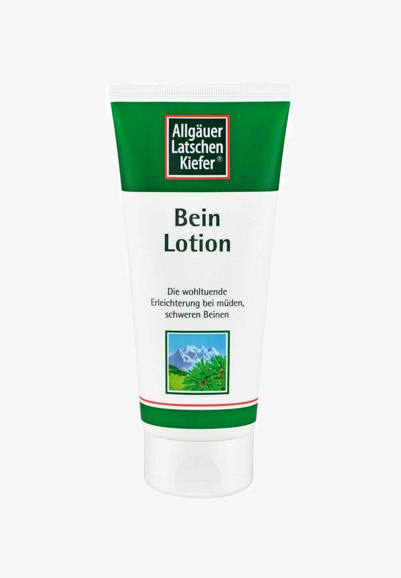 Weißer Tubus mit grünen Akzenten, beschriftet mit "Bein Lotion." Enthält eine Illustration von Bergen und Grünflächen. Der Text auf Deutsch beschreibt die Anwendung.