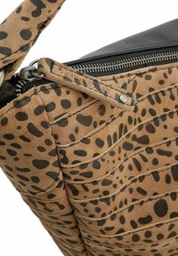 Borsa a mano in suede beige con motivo a macchie nere, dotata di chiusura con zip, pannelli testurizzati e una tracolla in pelle. Dettaglio della zip visibile.