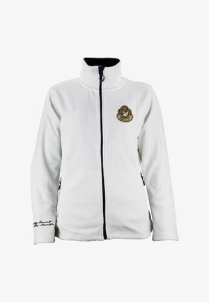 Veste en polaire blanche avec un col haut, fermeture éclair noire et poches latérales, présentant un emblème brodé en or sur la poitrine et du texte sur la manche.