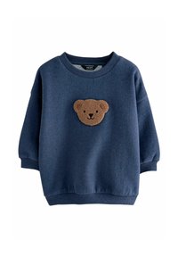 Sötétkék pulóver puha anyagból, az elején egy textúrázott barna medve arc díszítéssel, bordás mandzsettákkal és alsó szegéllyel.