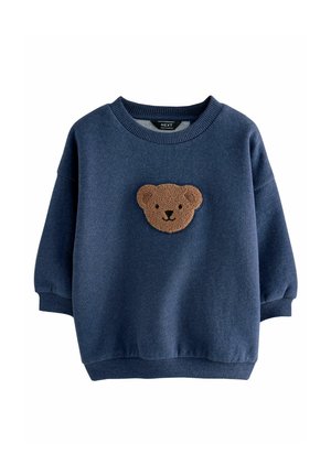 Navyblauwe sweatshirt van zacht materiaal, met een geappliqueerd textuurpatroon van een bruine berenkop aan de voorkant en geribde manchetten en onderrand.