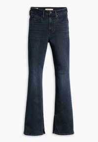 Mörkblå vida jeans med hög midja, som har en lätt split i fållen. Tillverkade av denim med en jämn textur och måttlig elasticitet.