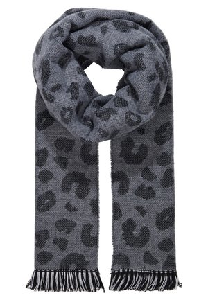 Écharpe en tricot gris à pois léopard noirs avec des franges noir et blanc aux deux extrémités, pliée avec une boucle en haut.