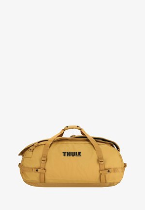 Thule duffel bag in mustard yellow, made of durable fabric. Features dual handles, adjustable straps, and a large main compartment. Logo visible.