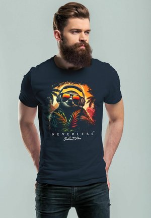 Navy blue cotton t-shirt featuring a colorful graphic of a sloth with headphones, surrounded by tropical leaves and sunset hues.