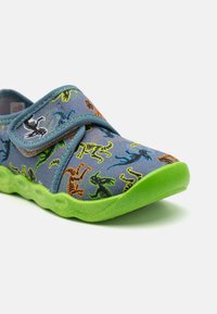 Lightweight, blue canvas shoe with colorful dinosaur patterns, Velcro strap, and a green rubber sole. Smooth texture, rounded toe design.