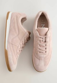 Baskets en suede rose avec un bout arrondi, un design à lacets, une semelle intermédiaire blanche et une semelle extérieure en caoutchouc à base de gomme ; texture lisse et détails de couture courbés.