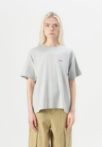 Gray cotton t-shirt with short sleeves and a rounded neckline featuring a pink and black "BE GOOD" graphic on the left chest.
