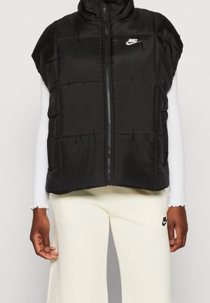 Zwarte gewatteerde mouwloze vest met een hoge kraag, voorzien van een rits aan de voorkant en een klein wit Nike-logo op de linkerborst.