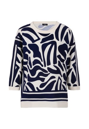 White sweater with navy blue abstract shapes and three-quarter sleeves, ribbed neckline, cuffs, and hem, labeled TUZZI.