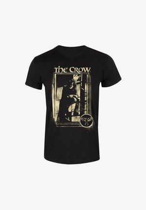 Sort bomuld t-shirt med guld grafisk print af en figur fra "The Crow", med indviklede detaljer og slidt tekstur.
