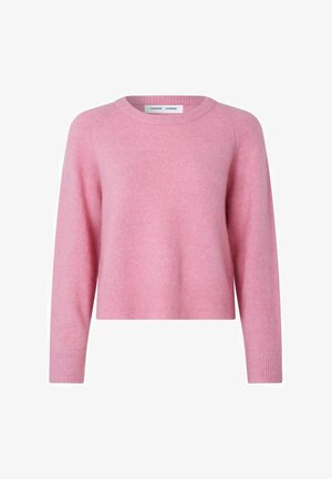 Bolyhos rózsaszín pulóver kerek nyakkivágással, hosszú ujjaival, bordázott mandzsettákkal és aljjal. Puha tapintású, rövidített fazonú. Címke látható a nyakkivágás belsejében.