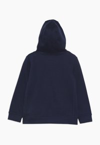 Felpa blu navy caratterizzata da un tessuto morbido, un cappuccio con cordino e polsini e orlo a costine. Texture liscia senza motivi visibili o accessori.