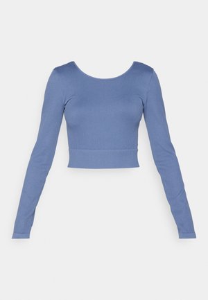 Long-sleeve, cropped top made of soft blue ribbed fabric. Features a round neckline and fitted design with minimal stitching detail.